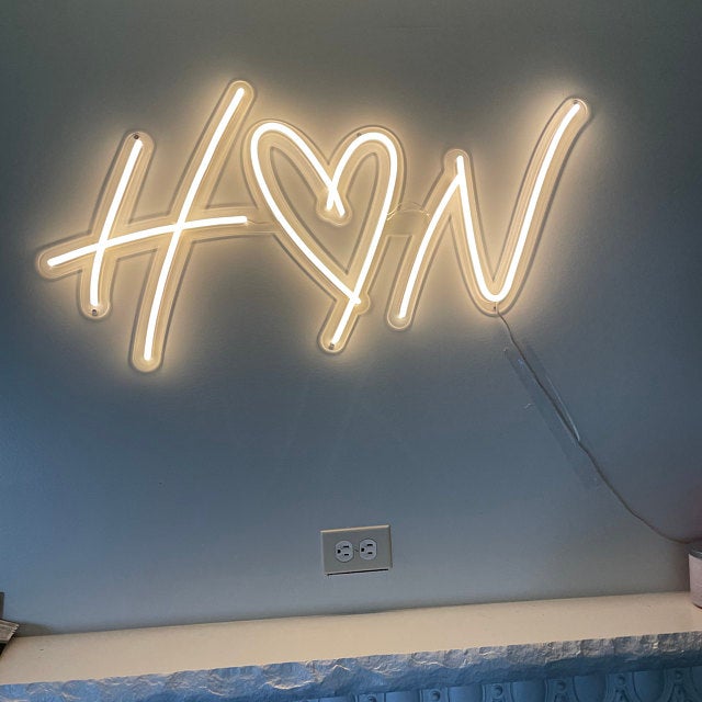 Light yellow neon sign hanged on the wall