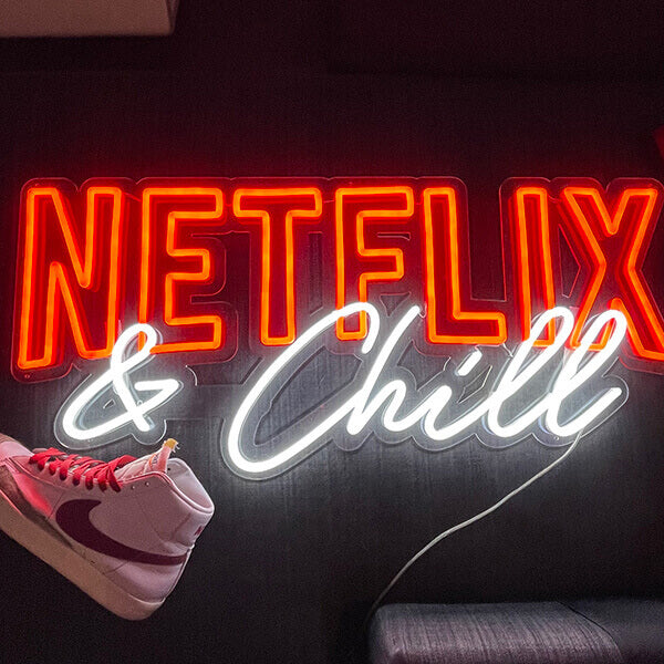 Red and white Netflix & chill neon sign next to a Nike shoe